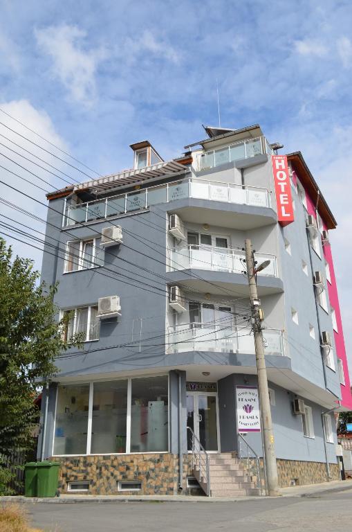 a building with a sign on the side of it at Hotel Kramus in Ruse