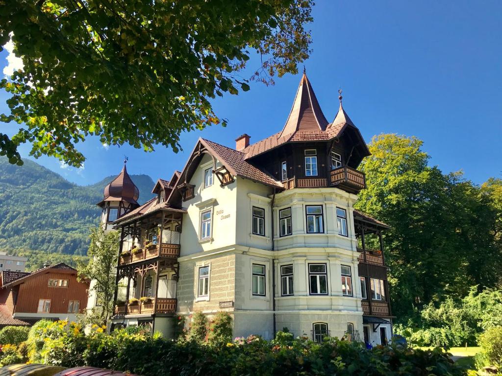 ein großes Haus mit einem Turm darüber in der Unterkunft Villa Traun in Bad Ischl