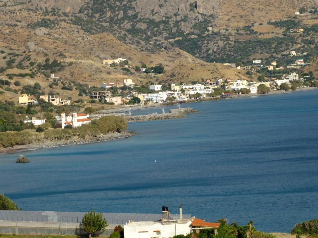 a view of a large body of water with houses at Endless Blue Apartments in Keratokampos