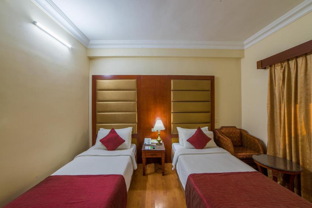 Postel nebo postele na pokoji v ubytování Raj Park Hotel Chennai