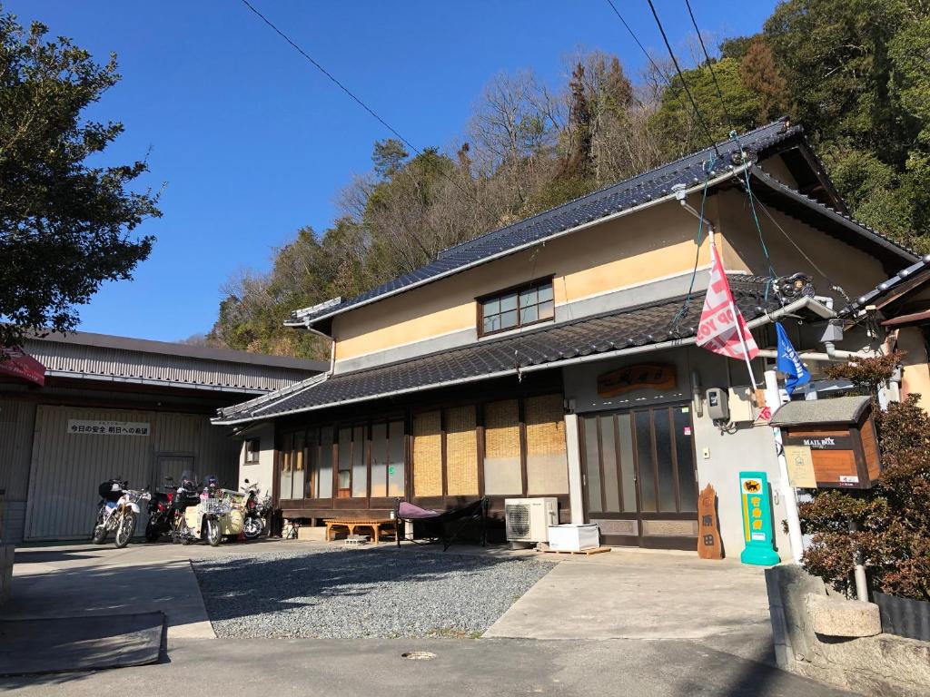 a building with motorcycles parked in front of it at Rider & Guest House Kazeyoubi in Fukuyama