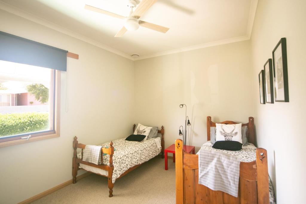 a bedroom with two beds and a window at Grace Cottage in Sheffield