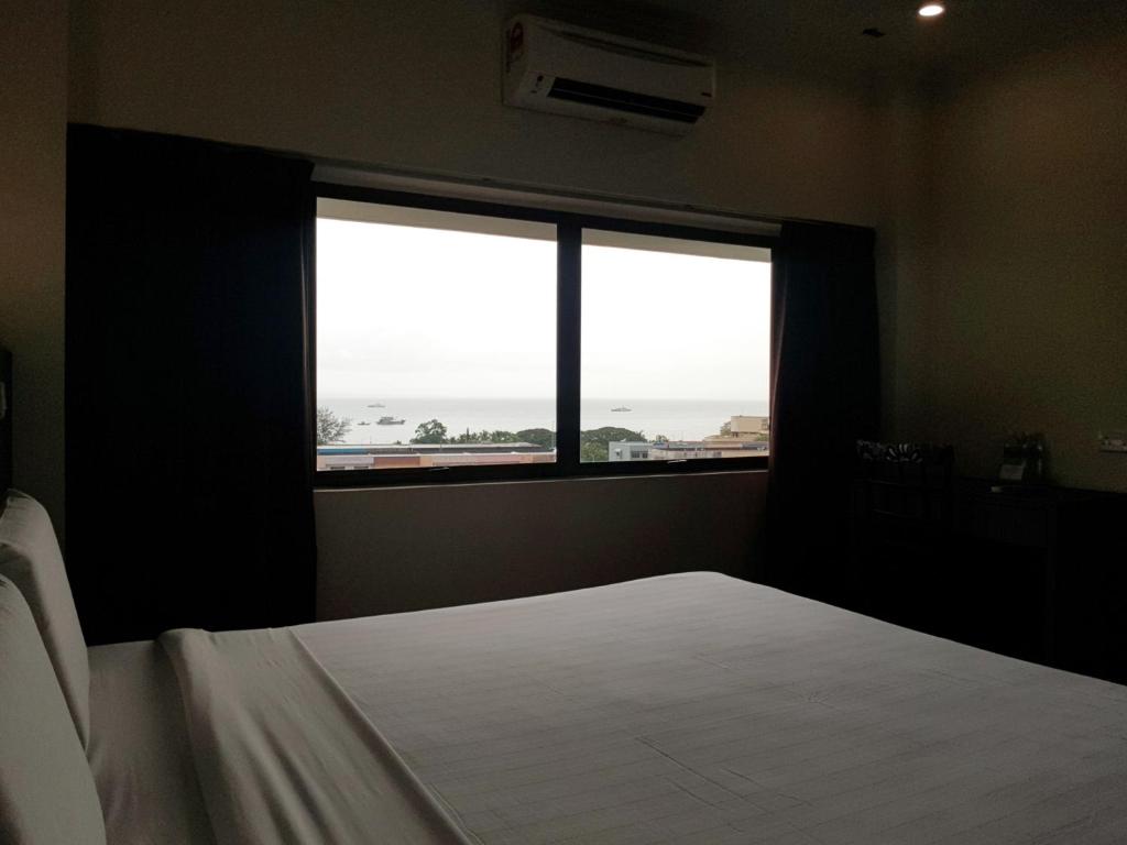 Postel nebo postele na pokoji v ubytování Check Inn Hotel Tawau