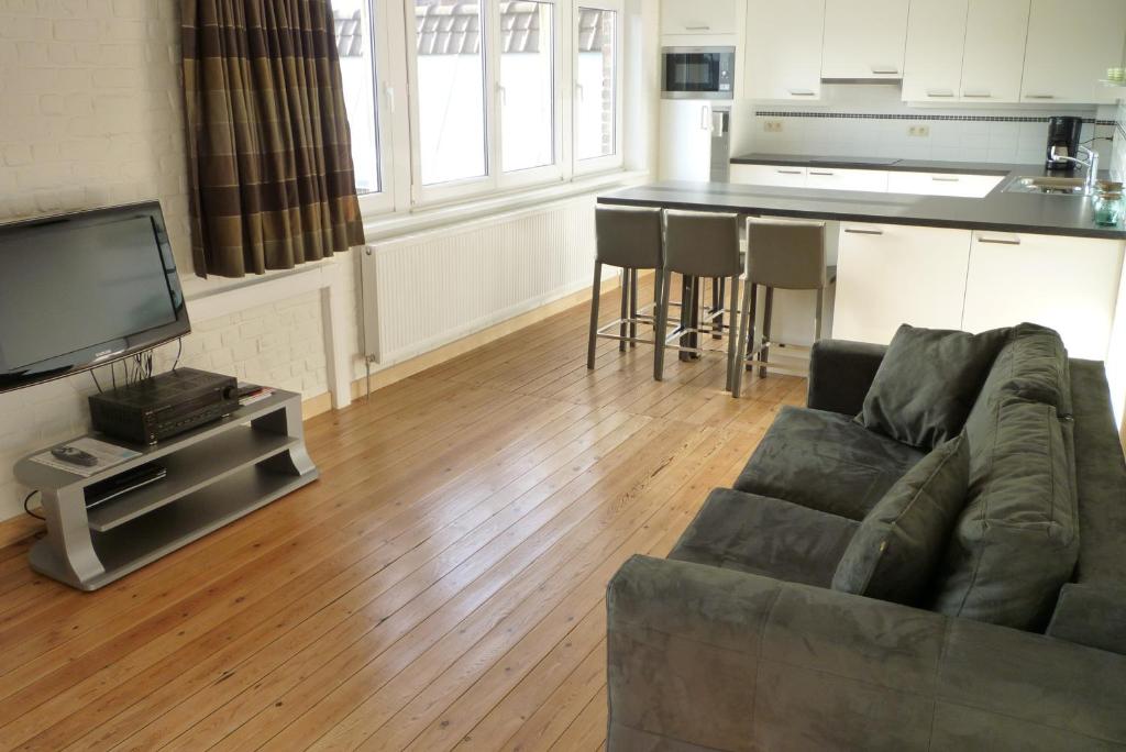 a living room with a couch and a kitchen at Apartment casuaLLoft in Kortrijk