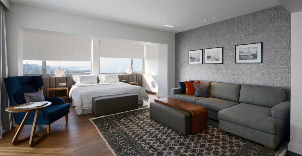 a hotel room with a bed and a couch at Makedonia Palace in Thessaloniki