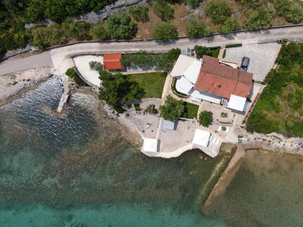 an aerial view of a house on the water at Apartmani Sandra i Davor Lonic in Kukljica