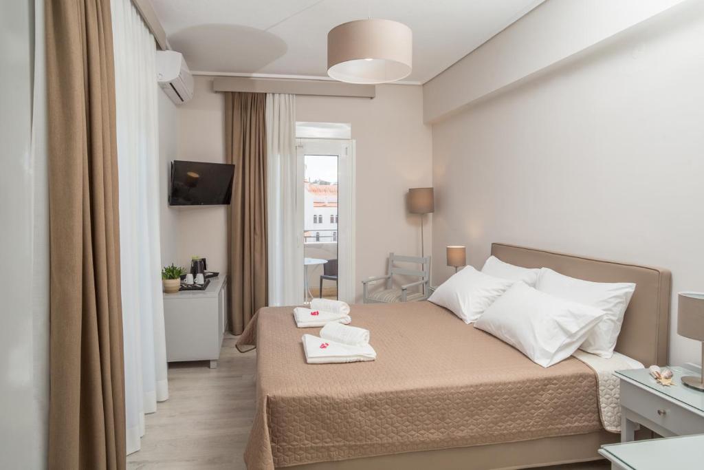 Postel nebo postele na pokoji v ubytování Hotel Alkyon