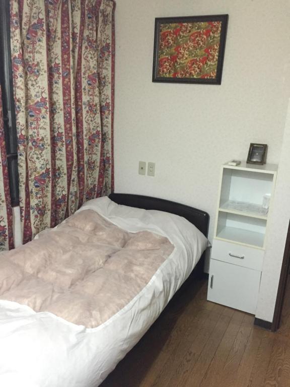 Postel nebo postele na pokoji v ubytování Tokyo Kakan