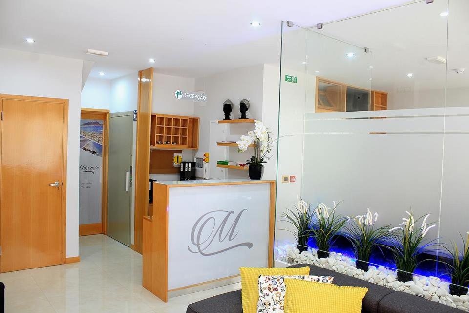 a kitchen with a fish tank in a room at Morenos Boutique Hotel in Mindelo