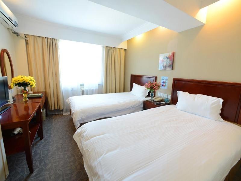 a hotel room with two beds and a television at GreenTree Inn Beijing Fangshan District Jingzhou Road Magezhuang Subway Station Express Hotel in Fangshan