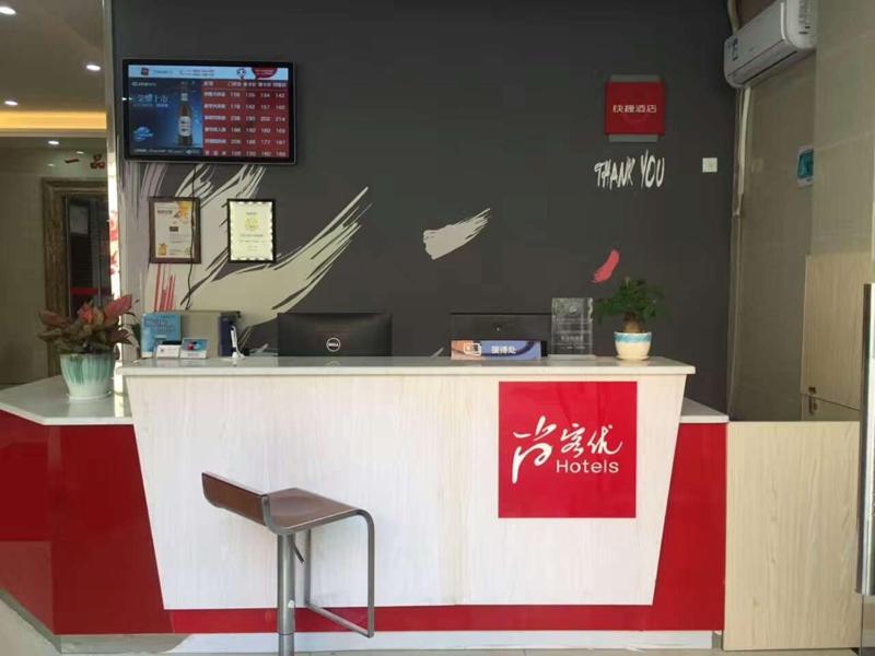 a red and white counter in a store with a chair at Thank Inn Chain Hotel guangdong shenzhen airport hourui metro station in Shenzhen