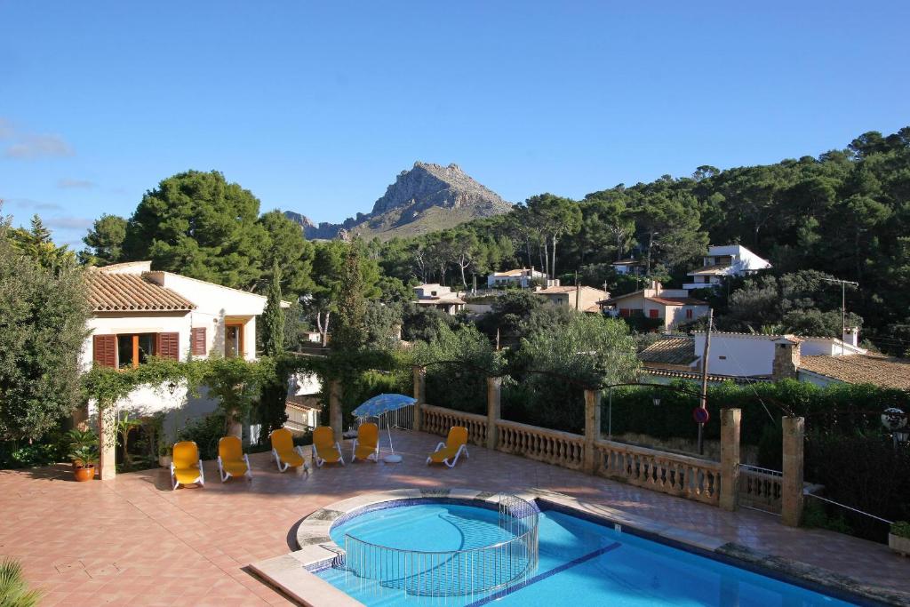 a villa with a swimming pool and a house at PINOS ALTOS 13 in Cala de Sant Vicenc