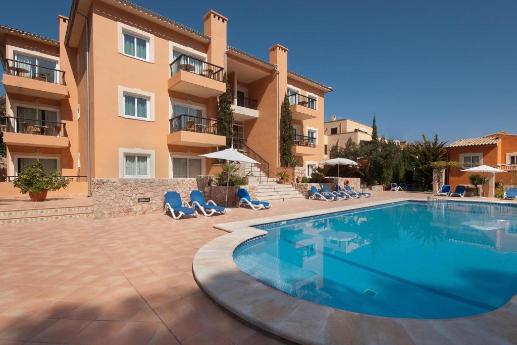 a swimming pool in front of a building at PINOS ALTOS 16 in Cala de Sant Vicenc
