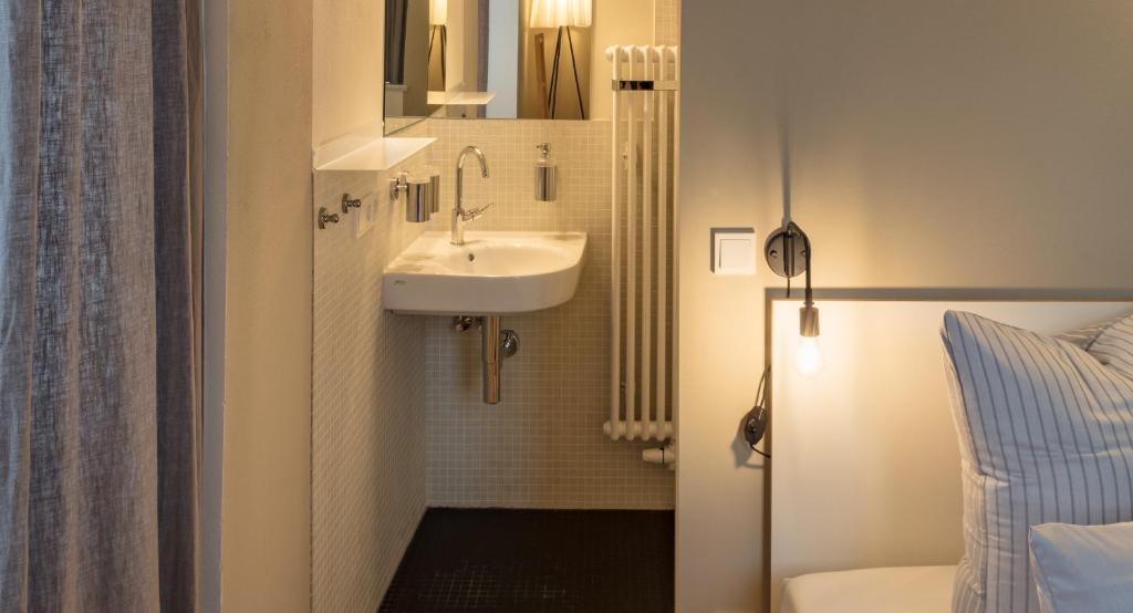 a small bathroom with a sink and a mirror at Schloss Prossen in Bad Schandau