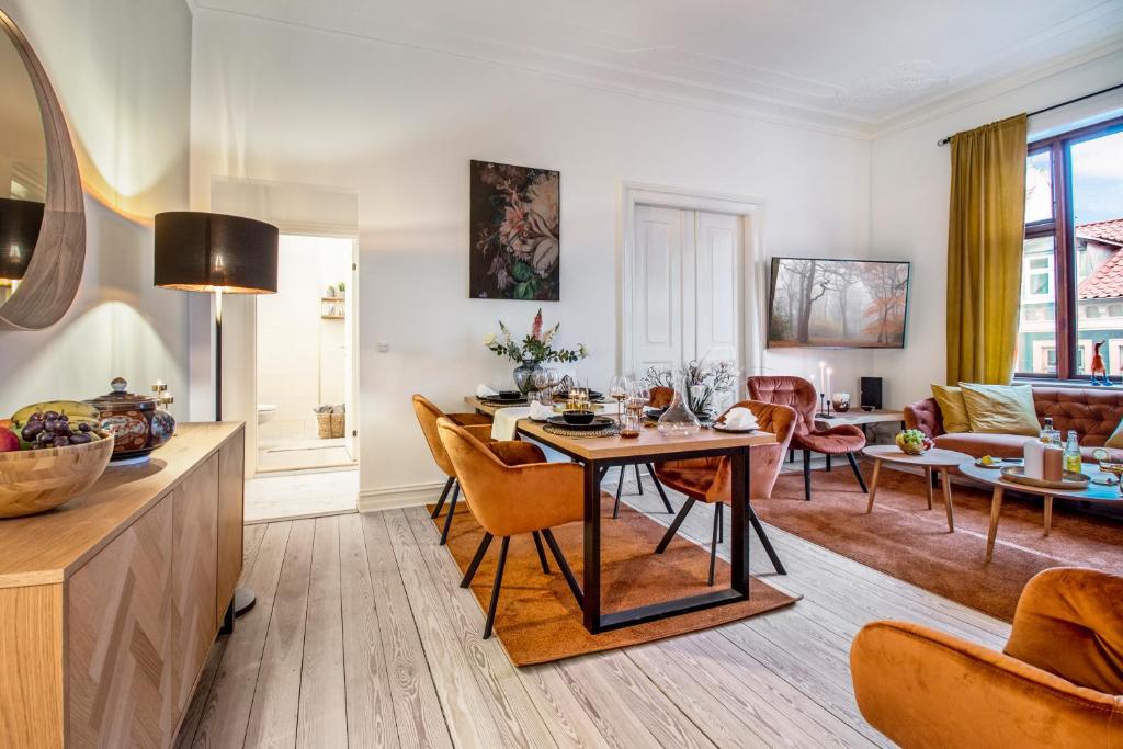a kitchen and living room with a table and chairs at The Modern Aarhus Getaway in Aarhus