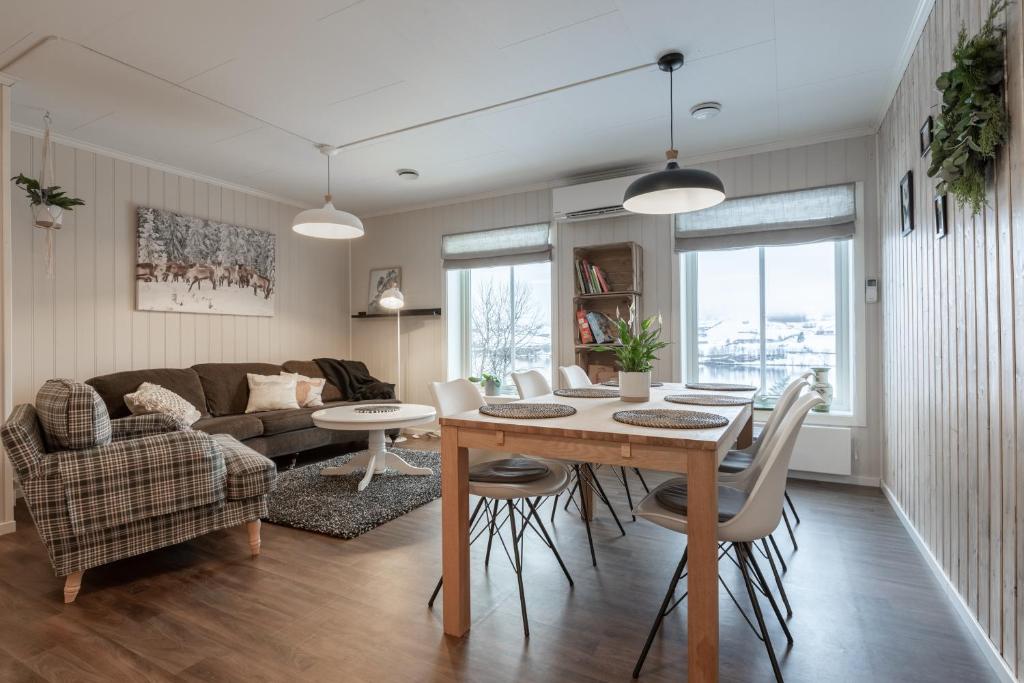 a living room with a table and chairs and a couch at SAGI 5 Apartment in Hafslo