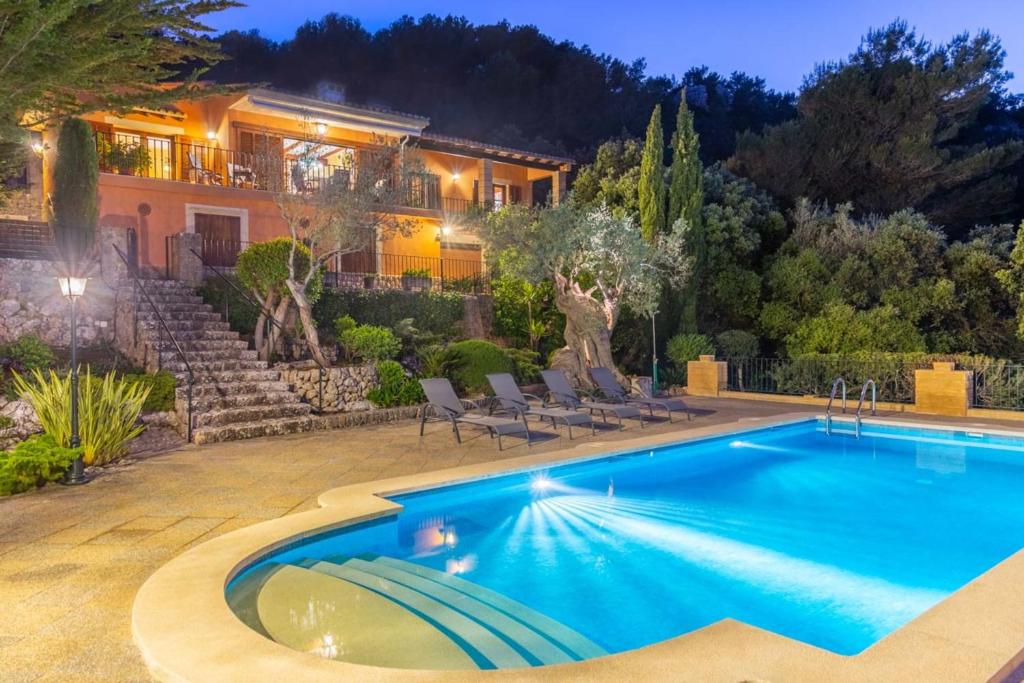 a house with a swimming pool in front of a house at Casa Bonaire Esporles in Esporles