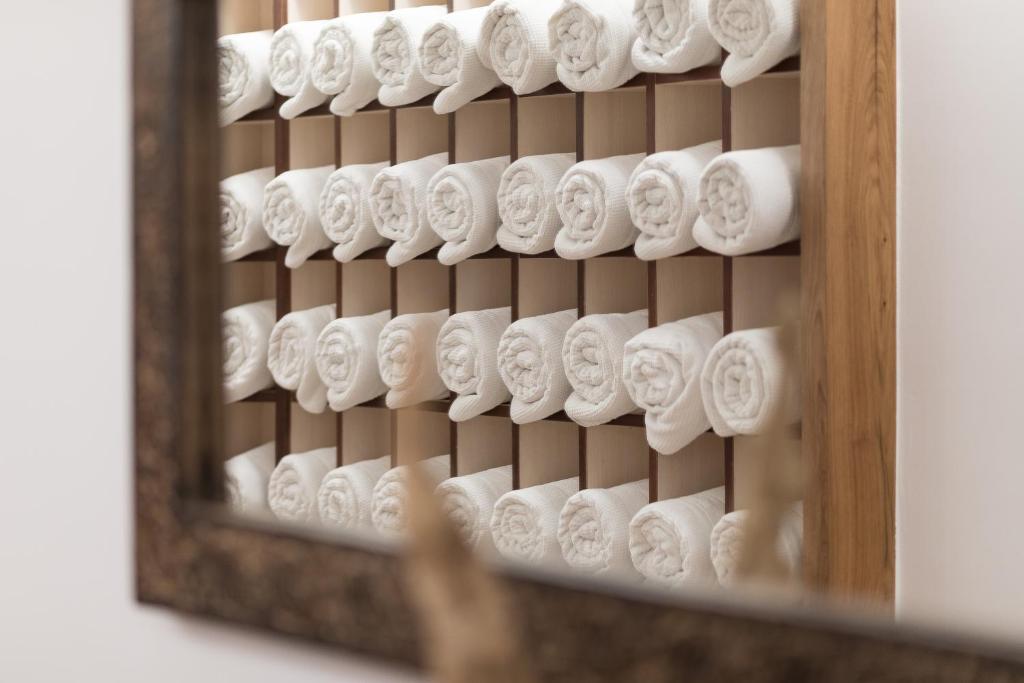 a bunch of rolls of toilet paper in a mirror at Hotel Albona Nova in Zürs am Arlberg