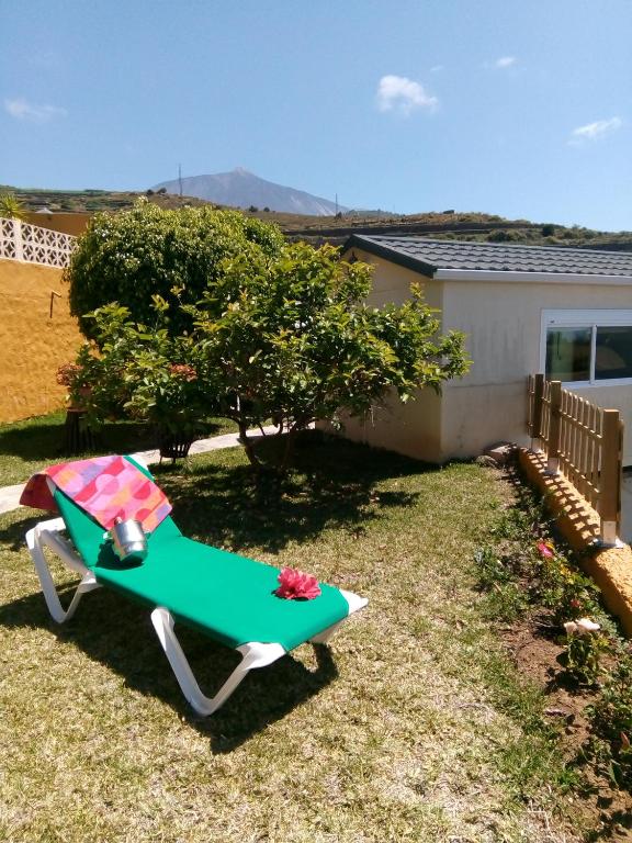 a green and white lawn chair in a yard at Tenerife Paradise 11 Bungalow - Hotel Rural Fsj in San Juan de la Rambla
