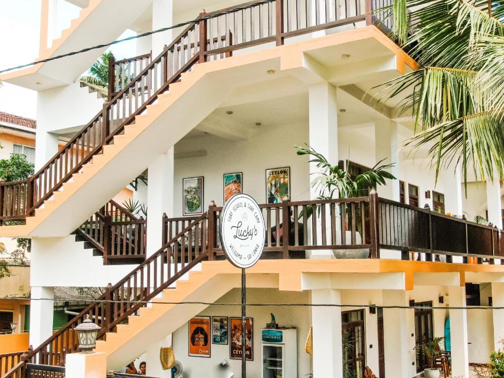 un bâtiment avec une horloge devant lui dans l'établissement Lucky's Surf Camp, à Weligama