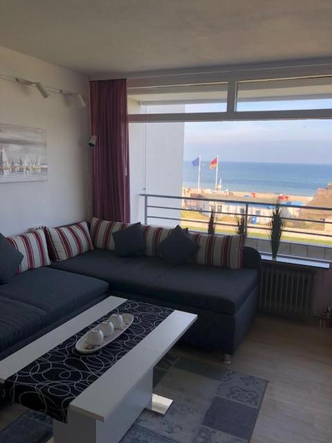a living room with a couch and a view of the ocean at Strandhotel Wohnung 30 in Dahme