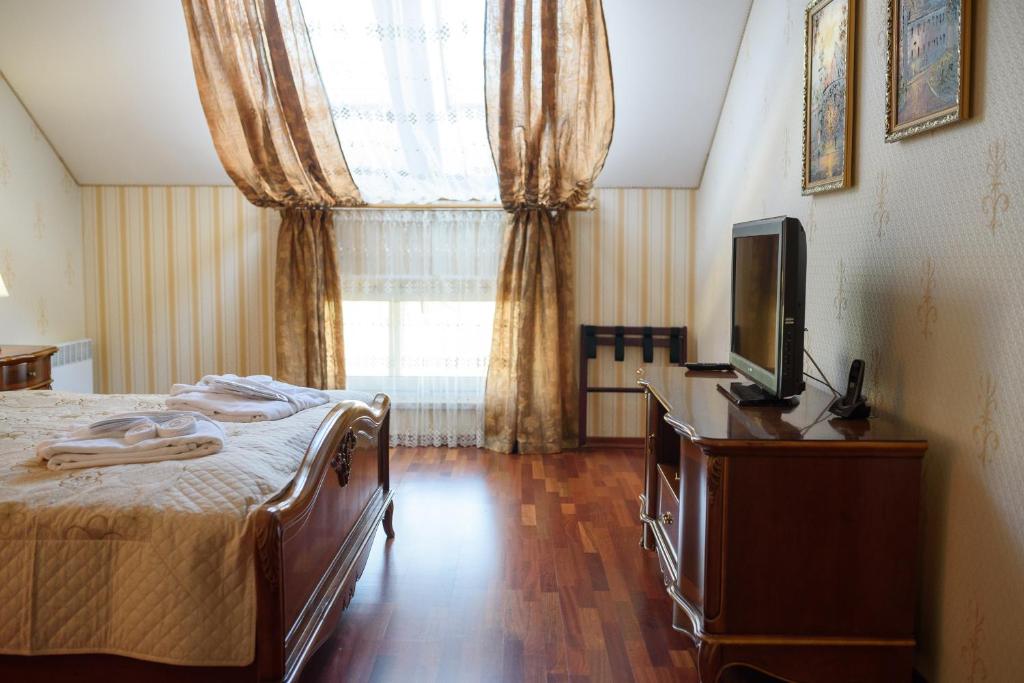 Postel nebo postele na pokoji v ubytování Apart-Hotel Chale Graal