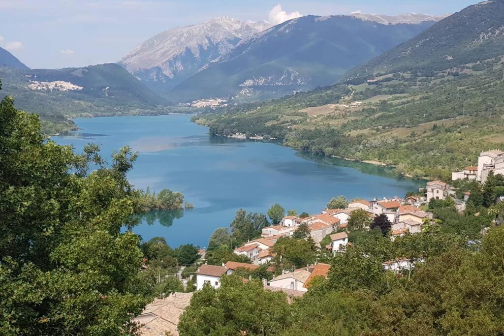 a view of a lake with houses and mountains at Borgo Delle Ginestre in Pescasseroli
