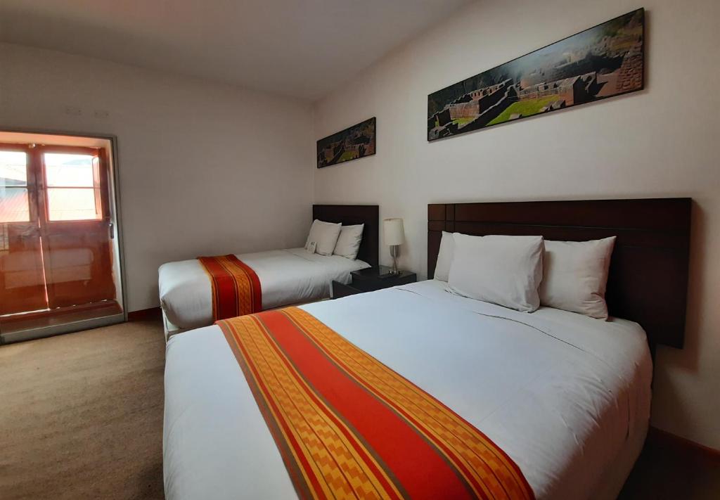 Postel nebo postele na pokoji v ubytování Hotel Sueños del Inka