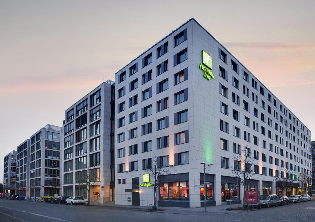 a large white building on a city street at Holiday Inn Berlin City East Side by IHG in Berlin