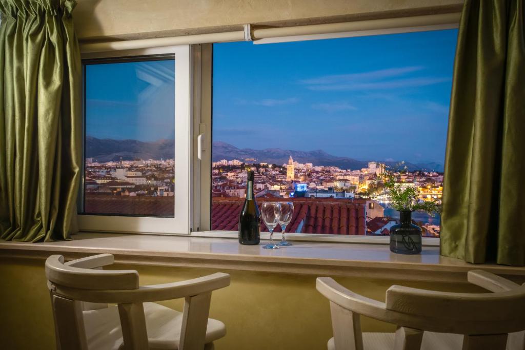 a window with a bottle of wine and two glasses at Royal Apartment Varos in Split