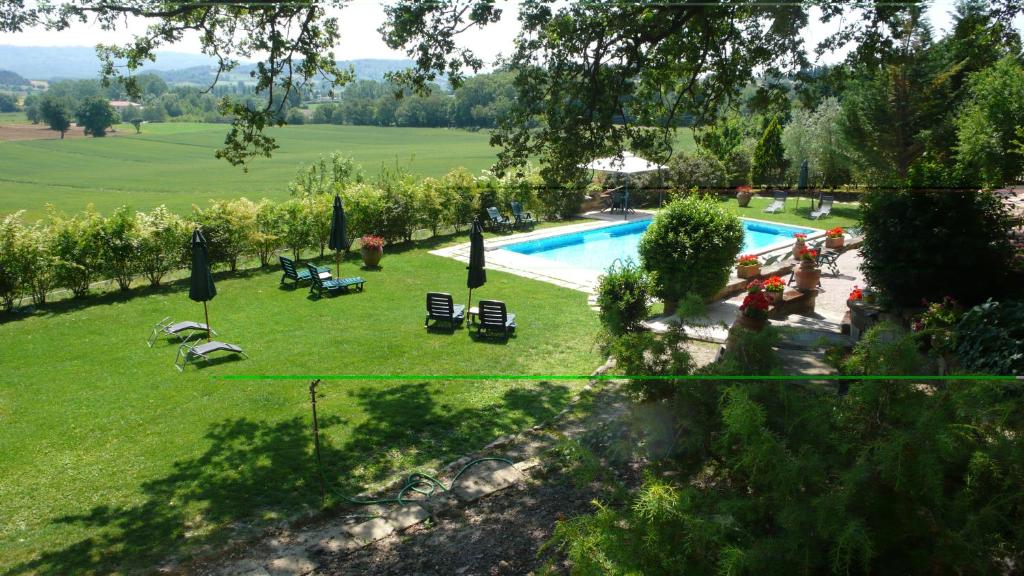 an image of a swimming pool in a garden at Podere Lamaccia - bed and kitchinette in Cetona