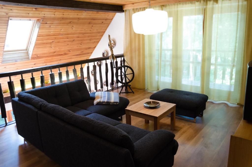 a living room with a couch and a table at Summer house near lake in Bukovec