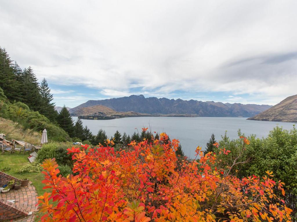 a view of a lake with a bunch of flowers at Crows Nest - Queenstown Holiday Home in Queenstown
