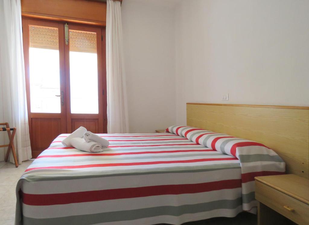 Postel nebo postele na pokoji v ubytování Hotel Saturno
