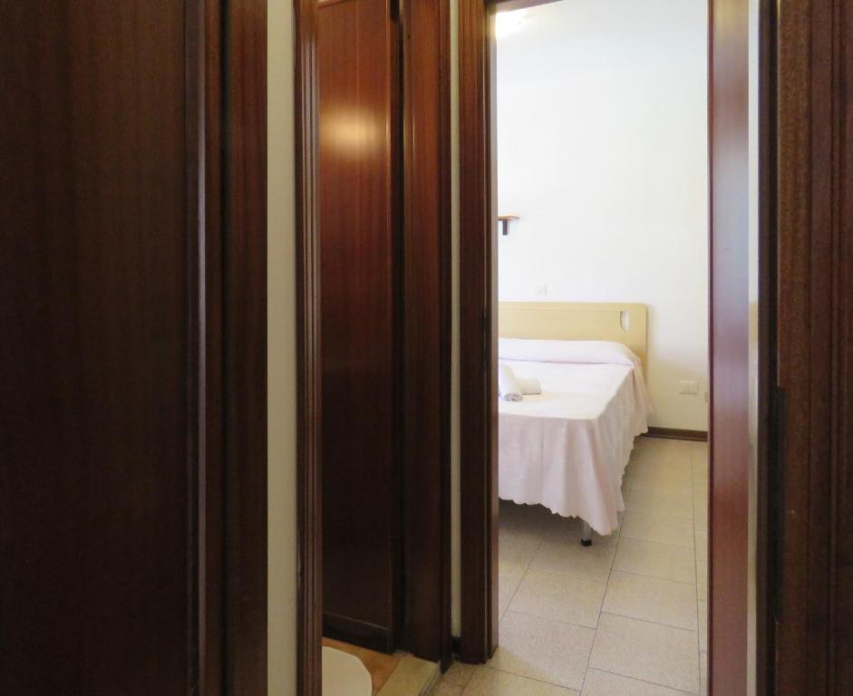 Postel nebo postele na pokoji v ubytování Hotel Saturno