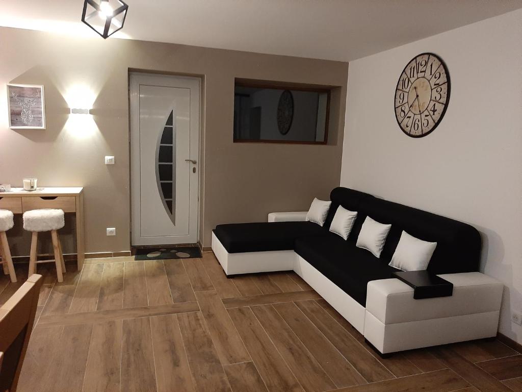 a living room with a black and white couch and a table at La Maison Trésallet in La Plagne Tarentaise