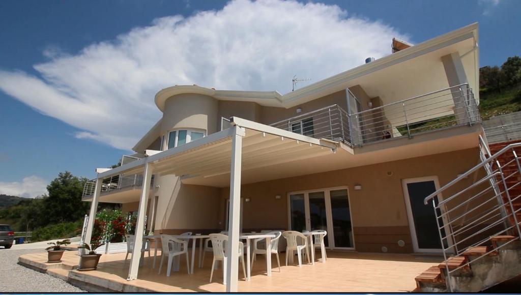 a house with a table and chairs in front of it at Stella Marina Agropoli in Agropoli