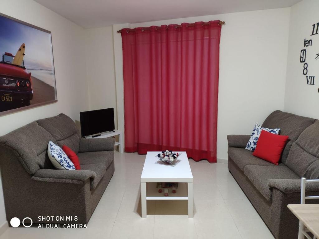a living room with two couches and a table at SATI 2 A in Santa Cruz de la Palma