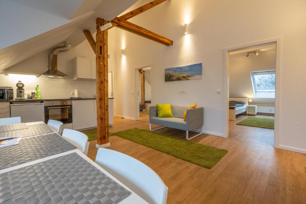 a kitchen and living room with a table and chairs at Wohnen wie zu Hause in Essen