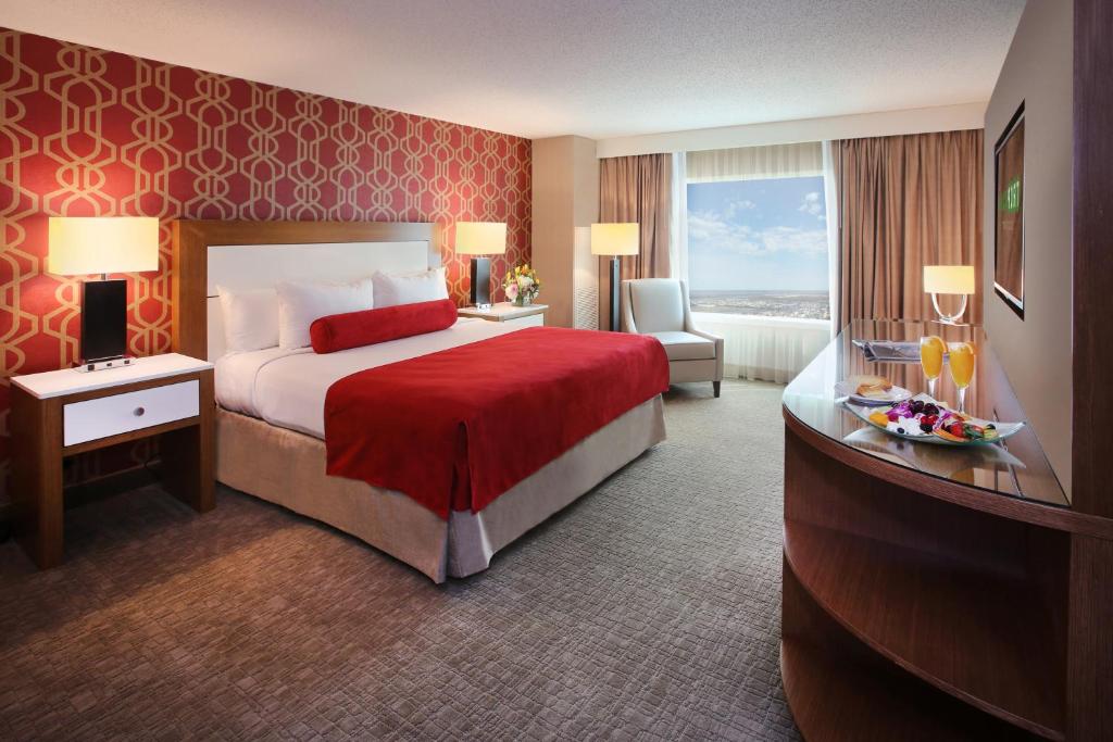 a hotel room with a bed with a red wall at Tropicana Casino and Resort in Atlantic City