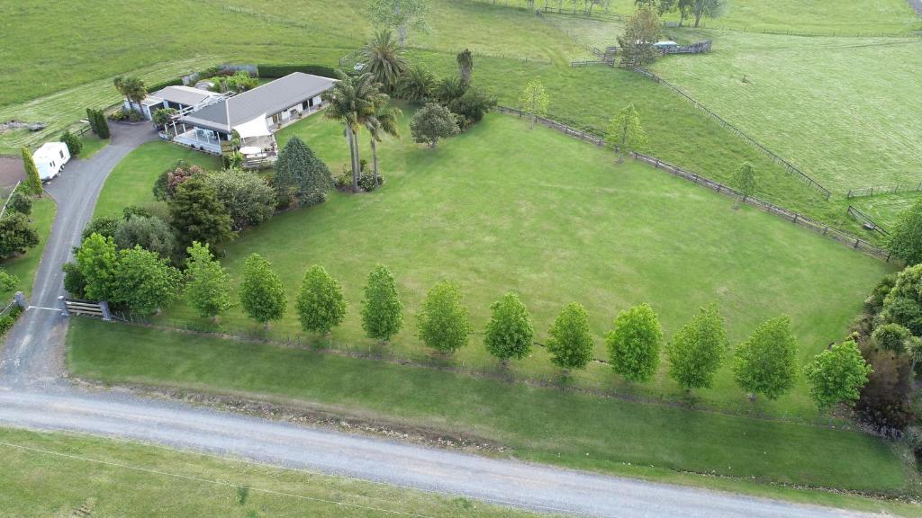 an aerial view of a house with a yard at Rural Palms in Haruru