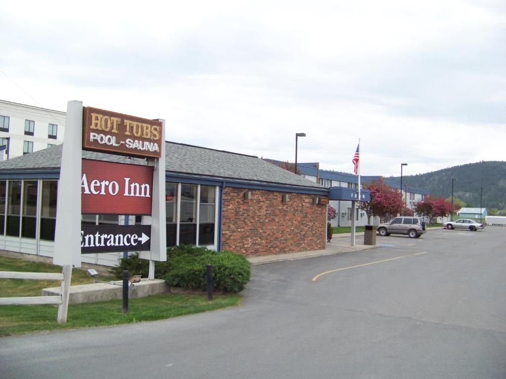 a sign in the parking lot of a store at Aero Inn in Kalispell