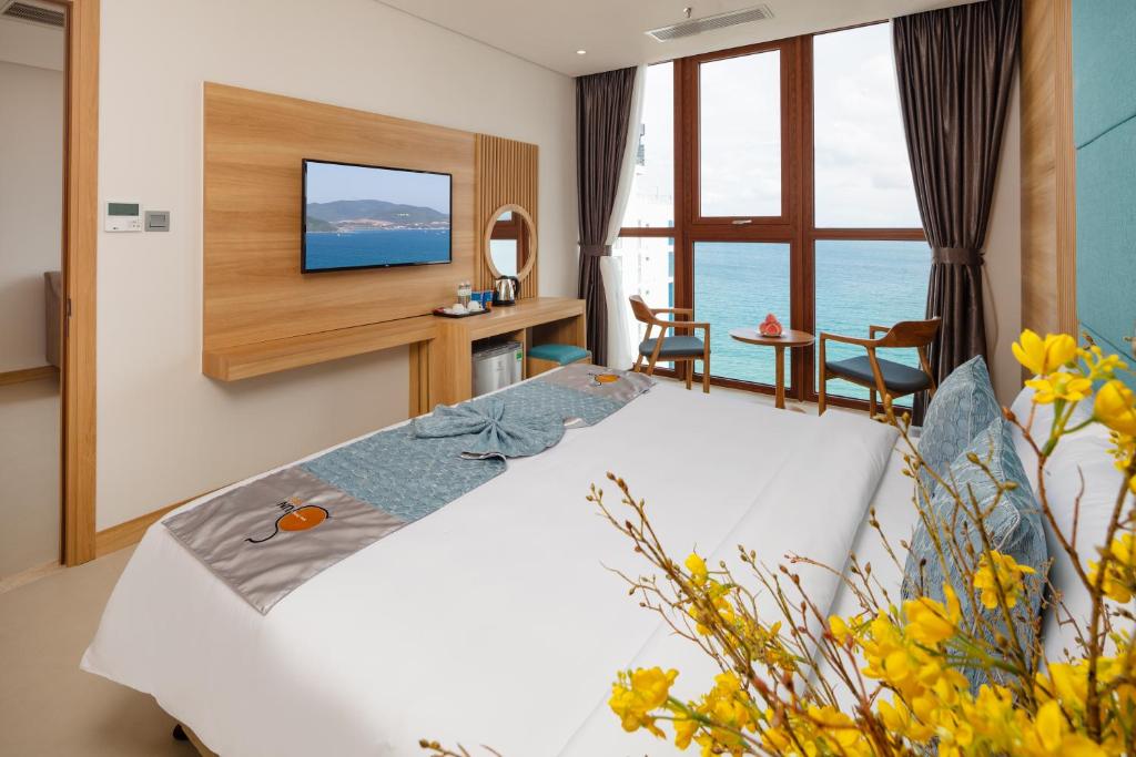 Postel nebo postele na pokoji v ubytování Sun Kiss Hotel
