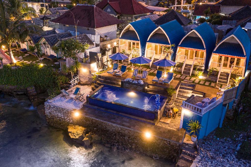 an aerial view of a house with a swimming pool at night at Aqua Vista Villa in Nusa Lembongan