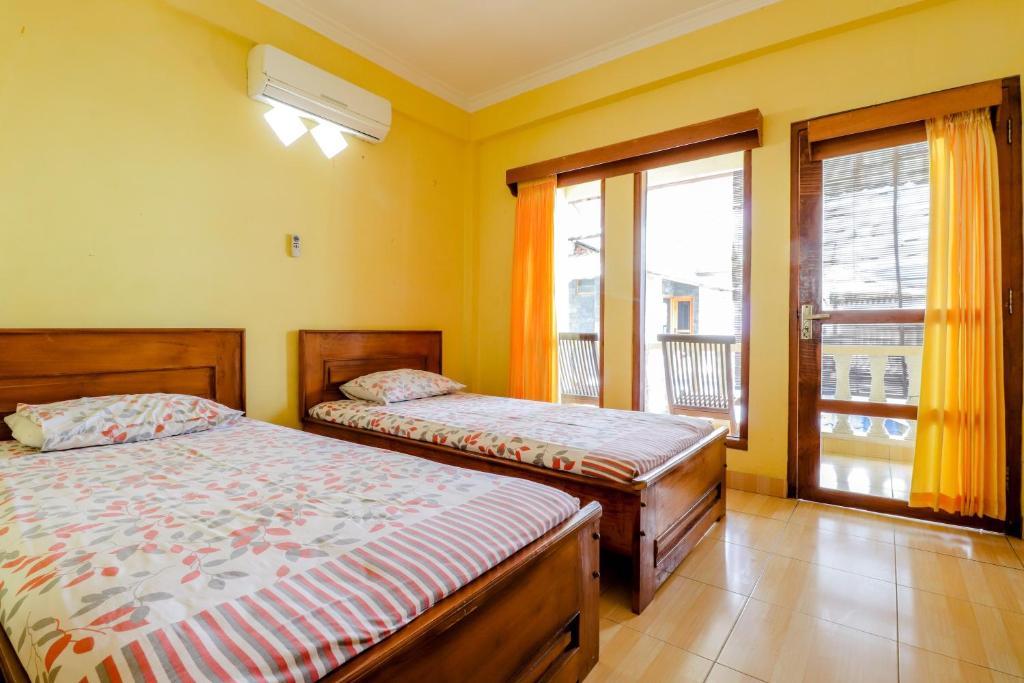 Postel nebo postele na pokoji v ubytování Adinda Beach Hotel and Villa
