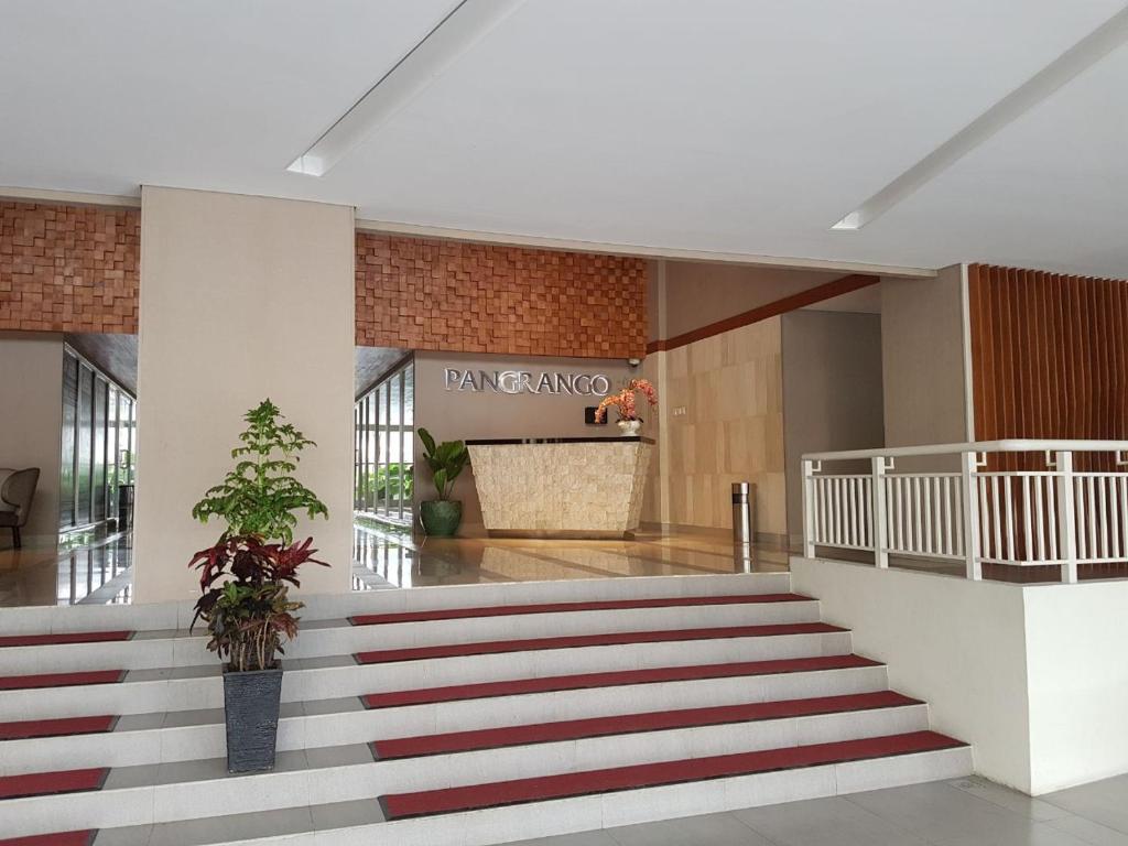 a lobby with a staircase in a building at Brand new and sweet @ apartemen parahyangan residence bandung in Bandung