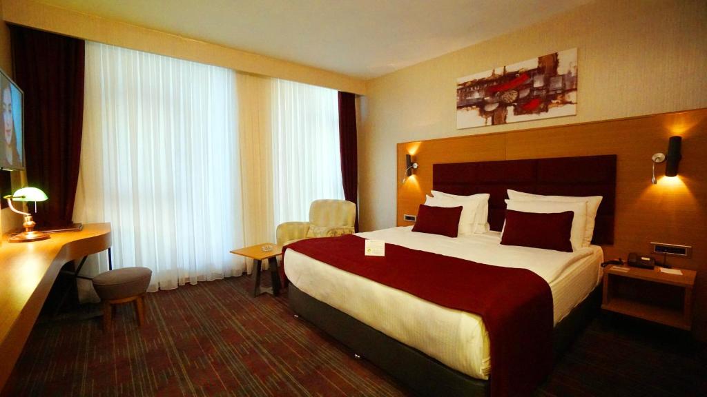 Postel nebo postele na pokoji v ubytování New Garden Hotel