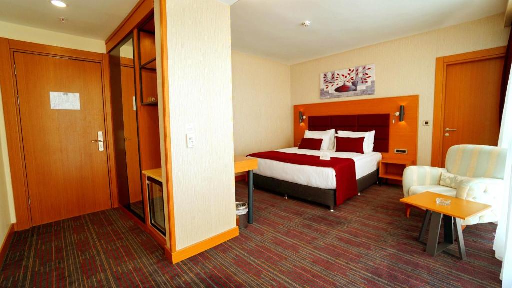 Postel nebo postele na pokoji v ubytování New Garden Hotel