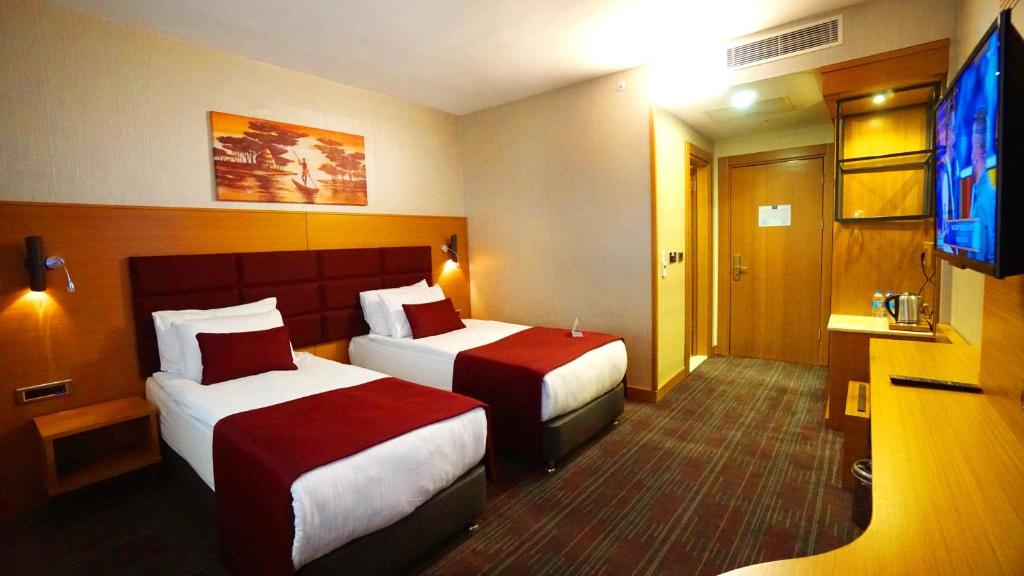 Postel nebo postele na pokoji v ubytování New Garden Hotel
