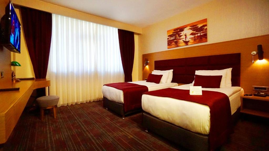 Postel nebo postele na pokoji v ubytování New Garden Hotel